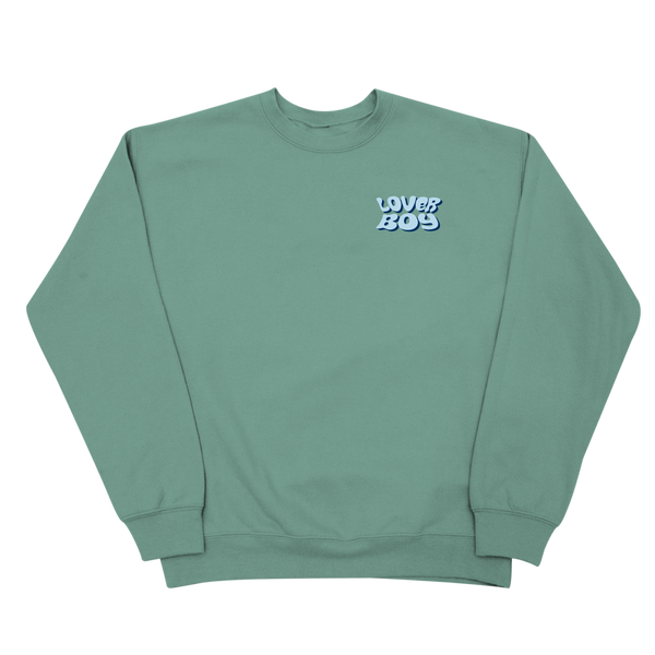 A sage green crewneck sweatshirt with a small light blue and navy 'LOVERBOY' graphic on the left chest, displayed flat against a solid white background.