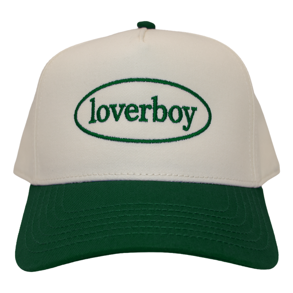 An off-white and dark green  five-panel style baseball cap with 'loverboy' embroidered in green inside an oval on the front panel.